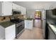 Well-equipped kitchen features stainless appliances, tile backsplash and access to outdoor deck at 11722 Hartland Dr, Indianapolis, IN 46229