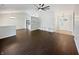 Inviting living room with sleek wood floors, modern fan, and recessed lighting at 11722 Hartland Dr, Indianapolis, IN 46229