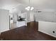 Open floor plan living room featuring stylish floors, pendant lighting, and kitchen access at 11722 Hartland Dr, Indianapolis, IN 46229