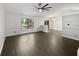Open-concept living area with wood-look flooring, large windows, and access to the dining space at 11722 Hartland Dr, Indianapolis, IN 46229