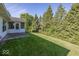 Manicured lawn and backyard offering plenty of outdoor space and privacy with mature trees at 11830 Sand Creek Blvd, Fishers, IN 46037