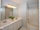 Bathroom featuring double sinks, a shower-tub combo, and neutral tones for a clean and modern feel at 11830 Sand Creek Blvd, Fishers, IN 46037