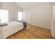 Neutral bedroom featuring hardwood floors, two windows for natural light, and a white door at 11830 Sand Creek Blvd, Fishers, IN 46037