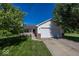 Charming single-story home with a well-manicured lawn and attached two-car garage at 11830 Sand Creek Blvd, Fishers, IN 46037