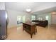 Open floor plan with a kitchen island, stainless steel refrigerator, and a living room with a brown sofa at 11830 Sand Creek Blvd, Fishers, IN 46037