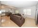 Spacious living room featuring a brown corduroy sofa, light wood floors, and natural light at 11830 Sand Creek Blvd, Fishers, IN 46037