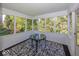 Enclosed sunroom featuring large windows and a table, offering a bright and airy space at 11830 Sand Creek Blvd, Fishers, IN 46037