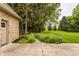 Tranquil backyard featuring a brick house, garden beds, and a sprawling green lawn at 1229 Helford Ln, Carmel, IN 46032