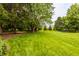 Expansive backyard with well-manicured lawn and mature trees, perfect for outdoor activities at 1229 Helford Ln, Carmel, IN 46032