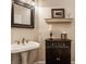 Stylish powder room featuring a pedestal sink, elegant fixtures, and decorative accents, ideal for guests at 1229 Helford Ln, Carmel, IN 46032