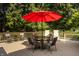 Outdoor deck with a table, chairs and red umbrella, perfect for entertaining and enjoying the backyard at 1229 Helford Ln, Carmel, IN 46032