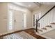 Inviting foyer with hardwood floors, staircase, and decorative rug at 1229 Helford Ln, Carmel, IN 46032