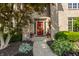 Close-up of the front door with sidelights, potted plants, and stone walkway at 1229 Helford Ln, Carmel, IN 46032