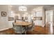 Eat-in kitchen with hardwood floors, wooden table, and views of the surrounding cabinets at 1229 Helford Ln, Carmel, IN 46032
