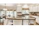 Open-concept kitchen with island cooktop, breakfast bar, and ample cabinet space at 1229 Helford Ln, Carmel, IN 46032