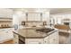 Spacious kitchen featuring a large island, cooktop, and white cabinetry at 1229 Helford Ln, Carmel, IN 46032