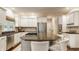 Well-lit kitchen with stainless steel appliances, granite countertops, and white cabinets at 1229 Helford Ln, Carmel, IN 46032