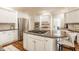 Spacious kitchen with granite countertops, stainless steel appliances, and a gas cooktop island at 1229 Helford Ln, Carmel, IN 46032
