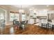 Open floor plan with kitchen island, breakfast nook with large windows, and hardwood flooring at 1229 Helford Ln, Carmel, IN 46032
