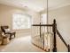 Charming upstairs landing with a bright window seat and elegant railing, creating a cozy transition space at 1229 Helford Ln, Carmel, IN 46032