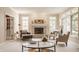 Bright living room featuring a stone fireplace, large windows, and ample seating at 1229 Helford Ln, Carmel, IN 46032