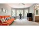 Inviting living room with a bay window and a stylish orange sofa, offering plenty of light at 1229 Helford Ln, Carmel, IN 46032