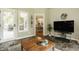 Inviting living room with slate floors, access to the outside, and a view into the dining room at 1229 Helford Ln, Carmel, IN 46032