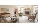 Elegant living room with stone fireplace, ample seating, and a neutral color palette at 1229 Helford Ln, Carmel, IN 46032