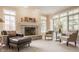 Bright living room with stone fireplace, large windows, and comfortable seating, perfect for relaxation at 1229 Helford Ln, Carmel, IN 46032