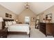 Spacious main bedroom with vaulted ceiling, large bed, and ample natural light, creating a peaceful retreat at 1229 Helford Ln, Carmel, IN 46032
