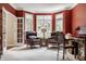 Inviting office space with rich, red walls, bright windows, and elegant furnishings for a productive workspace at 1229 Helford Ln, Carmel, IN 46032