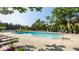 Sparkling community pool surrounded by lounge chairs, lush trees and elegant landscaping at 1229 Helford Ln, Carmel, IN 46032