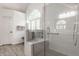 Modern walk-in shower with tile surround, a built-in bench, and a glass partition at 1229 Helford Ln, Carmel, IN 46032