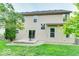 A large backyard with green grass, patio, and mature trees at 12679 Chargers Ct, Fishers, IN 46037