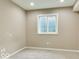 Basement room with a window providing natural light and carpet flooring at 12679 Chargers Ct, Fishers, IN 46037