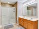 Bathroom featuring double sink vanity, tile shower with glass doors, and modern lighting at 12679 Chargers Ct, Fishers, IN 46037