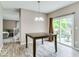 Dining area with hardwood style flooring and view of the backyard through sliding glass doors at 12679 Chargers Ct, Fishers, IN 46037