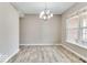 Open dining area featuring wood floors and a modern chandelier, perfect for entertaining at 12679 Chargers Ct, Fishers, IN 46037