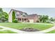 Lovely two-story home with lush green lawn, mature trees, and blooming flower beds at 12679 Chargers Ct, Fishers, IN 46037