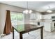 Dining area featuring hardwood style flooring adjacent to kitchen with white cabinets at 12679 Chargers Ct, Fishers, IN 46037