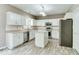 Bright kitchen with white cabinets, stainless appliances, island, and hardwood style flooring at 12679 Chargers Ct, Fishers, IN 46037