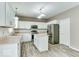 Modern kitchen features white cabinets, stainless steel appliances, and a functional center island at 12679 Chargers Ct, Fishers, IN 46037