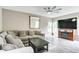 Inviting living room with a large sectional, a fireplace, and a flat-screen TV at 12679 Chargers Ct, Fishers, IN 46037