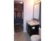Bathroom featuring a dark vanity, a large mirror, and a walk-in closet nearby at 12901 N Collett Way, Camby, IN 46113