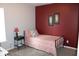 Comfortable bedroom featuring a red accent wall and warm-toned decor at 12901 N Collett Way, Camby, IN 46113