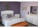 Charming bedroom featuring a white bed, a decorative wreath, and light purple walls at 12901 N Collett Way, Camby, IN 46113