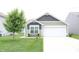 Charming one-story home with a well-manicured lawn and a two-car garage, offering great curb appeal at 12901 N Collett Way, Camby, IN 46113