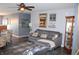 Comfortable living room featuring a gray sofa, stylish decor, and a ceiling fan for added comfort at 12901 N Collett Way, Camby, IN 46113