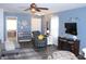 Relaxing living room with fireplace, ceiling fan, comfortable seating, and stylish decor elements at 12901 N Collett Way, Camby, IN 46113