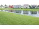 Picturesque pond view, showcasing the reflection of colorful neighborhood homes at 12901 N Collett Way, Camby, IN 46113